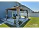 Covered patio with pergola, comfortable seating area, and well-manicured lawn at 171 Crownpiece St, Troutman, NC 28166