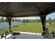 View from under the covered patio of a grassy backyard and treeline at 171 Crownpiece St, Troutman, NC 28166