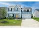 Two-story house with gray siding, two-car garage, and landscaped lawn at 171 Crownpiece St, Troutman, NC 28166