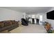 Open living room with a comfortable couch and a view of the kitchen at 171 Crownpiece St, Troutman, NC 28166