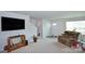 Living room with recliner, tv, and view of the entryway and stairs at 171 Crownpiece St, Troutman, NC 28166