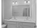 Modern bathroom showcasing double vanity with white countertops and a large mirror at 19765 Feriba Pl, Cornelius, NC 28031
