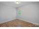 A bright bedroom showcasing wood-look flooring and natural light at 19765 Feriba Pl, Cornelius, NC 28031
