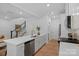 Open kitchen with breakfast bar, stainless steel appliances, and ample storage at 19765 Feriba Pl, Cornelius, NC 28031