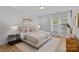 Cozy main bedroom with soft lighting, neutral tones, and large windows at 19765 Feriba Pl, Cornelius, NC 28031