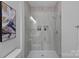 Elegant walk-in shower showcases decorative tiles, glass door, and built-in storage niches at 19765 Feriba Pl, Cornelius, NC 28031