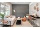 Living Room with a brick accent wall and modern furniture at 2000 Patio Ct # 108, Charlotte, NC 28205