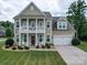 Two-story house with green siding, white columns, and a balcony at 2122 Capricorn Ave, Indian Trail, NC 28079