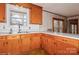 Kitchen boasts wood cabinets and double sink at 3100 Westerwood Dr, Charlotte, NC 28214