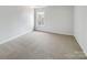 Simple bedroom with carpeted floors and a large window at 3217 Ian Patrick Ave, Kannapolis, NC 28083