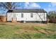 Back view of house with a well-maintained lawn, showcasing its inviting exterior and outdoor space at 3411 Rogers St, Charlotte, NC 28208