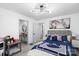 Modern bedroom with sleek flooring, a stylish light fixture, and a cozy bed with throw blanket and pillows at 3411 Rogers St, Charlotte, NC 28208