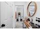 Bright hallway with modern flooring and a stylish mirror, leading to a well-appointed bathroom at 3411 Rogers St, Charlotte, NC 28208