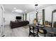 Open-concept living area featuring a dining space, comfortable seating, and abundant natural light at 3411 Rogers St, Charlotte, NC 28208