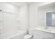 Clean, white bathroom featuring a bathtub, toilet, and vanity with a mirror at 3500 Backwater St, Concord, NC 28027