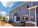 Rear exterior view of two-story home with vinyl siding, windows, and patio at 3500 Backwater St, Concord, NC 28027