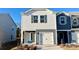 Two-story townhome with gray and white siding, a white garage door, and landscaping at 3530 Backwater St, Concord, NC 28027