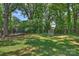 Spacious backyard with trampoline and hockey net, surrounded by lush greenery at 4311 Craig Ave, Charlotte, NC 28211
