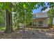 House backyard with covered patio and large trees at 4311 Craig Ave, Charlotte, NC 28211