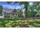 Large backyard with a home, trampoline and mature trees at 4311 Craig Ave, Charlotte, NC 28211