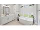 Bathroom with freestanding tub, double vanity, and large window at 4311 Craig Ave, Charlotte, NC 28211