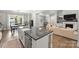 Open concept kitchen with island and views into living and dining areas at 4311 Craig Ave, Charlotte, NC 28211