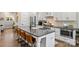 Modern kitchen features a large island with seating and stainless steel appliances at 4311 Craig Ave, Charlotte, NC 28211