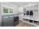 Laundry room with washer, dryer, built-in cabinets, and bench with shoe storage at 4311 Craig Ave, Charlotte, NC 28211