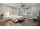 Spacious main bedroom with a king-size bed, window seating, and a ceiling fan at 4311 Craig Ave, Charlotte, NC 28211