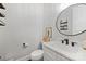 Modern powder room with a floating vanity, round mirror, and elegant fixtures at 4311 Craig Ave, Charlotte, NC 28211