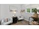 Cozy sitting area with two armchairs, a side table, and decorative wall art at 4311 Craig Ave, Charlotte, NC 28211
