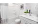 Clean bathroom with white vanity, shower/tub combo, and hex tile floor at 4614 Harris Elliot Rd, Lincolnton, NC 28092