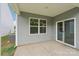 Covered back patio featuring neutral siding, an exterior window, and sliding glass door to enter the home at 4614 Harris Elliot Rd, Lincolnton, NC 28092