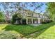 Backyard view of the property with a small patio, sliding glass doors, and grassy lawn at 7000 Quail Hill Rd, Charlotte, NC 28210