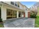 House exterior showcasing a concrete patio and view of the backyard with mature trees at 7000 Quail Hill Rd, Charlotte, NC 28210