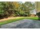 Backyard concrete patio and view of the surrounding trees and natural landscape at 7000 Quail Hill Rd, Charlotte, NC 28210