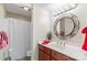Bathroom vanity with a round mirror, granite countertop, and a shower-tub combination at 7000 Quail Hill Rd, Charlotte, NC 28210