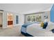 Bedroom featuring a blue accent wall, white trim, carpet flooring, and lots of natural light at 7000 Quail Hill Rd, Charlotte, NC 28210