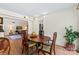 Dining room view featuring a wooden table set and an opening to a living room space at 7000 Quail Hill Rd, Charlotte, NC 28210