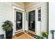 Cozy entryway with glass doors, welcoming mats, and potted plants offers a warm greeting at 7000 Quail Hill Rd, Charlotte, NC 28210