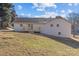 White brick home with a deck and sloping backyard at 706 Brook Forest Dr, Belmont, NC 28012