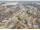 Aerial view of neighborhood with various houses and landscaping at 7705 Windsor Forest Pl, Harrisburg, NC 28075