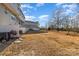 View of a backyard with dead grass and appliances near a white fence at 828 Renee Ave, Fort Mill, SC 29715