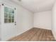Spacious basement area featuring durable laminate flooring and natural light streaming in through a door at 828 Renee Ave, Fort Mill, SC 29715