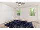Bright bedroom featuring a ceiling fan, neutral walls, and two windows offering natural light at 828 Renee Ave, Fort Mill, SC 29715