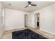 A bright bedroom with a view of a bathroom, a ceiling fan, and neutral walls at 828 Renee Ave, Fort Mill, SC 29715