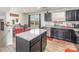 Kitchen island and dining area that features dark cabinets, granite countertops, and stainless appliances at 828 Renee Ave, Fort Mill, SC 29715