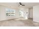 Bright living room with a ceiling fan, neutral carpet, and lots of natural light at 828 Renee Ave, Fort Mill, SC 29715
