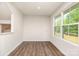 Bright room featuring laminate wood floors and natural light from a large window at 828 Renee Ave, Fort Mill, SC 29715