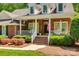Brick house with front porch, rocking chairs, and landscaped yard at 908 Thorn Ridge Ln, Lake Wylie, SC 29710